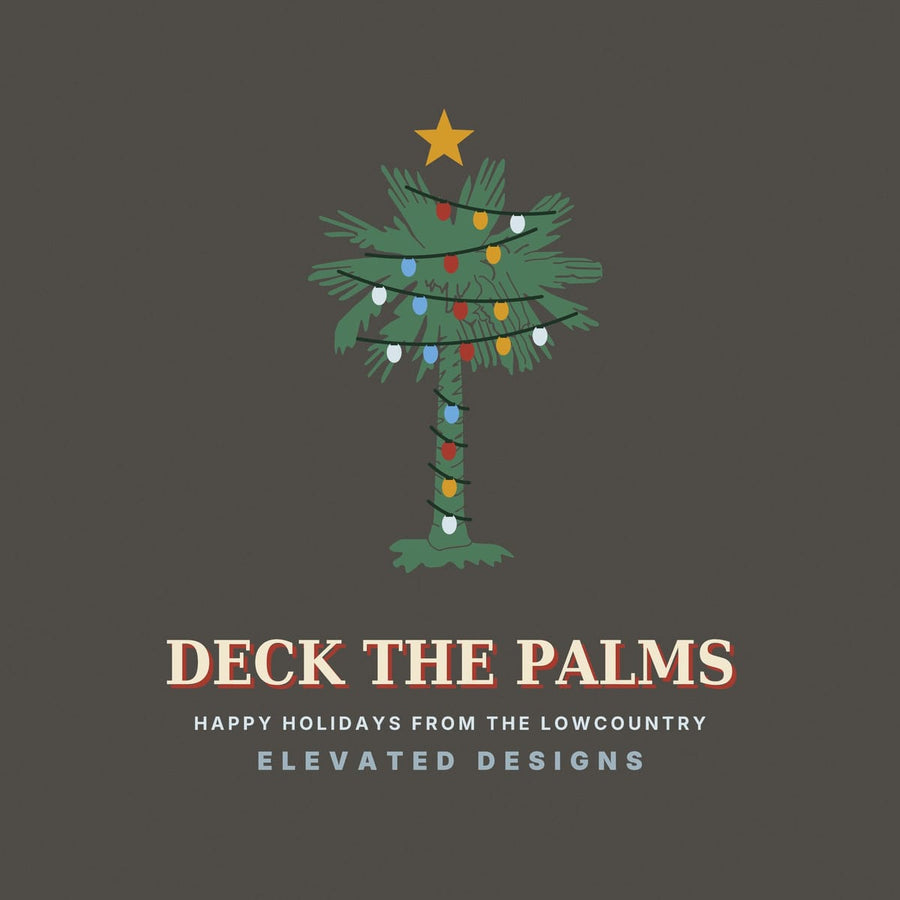 Close-up of the Deck the Palms print: a green palmetto with dark light strands looping across the fronds and trunk, red, gold, blue and white bulbs and a gold star.